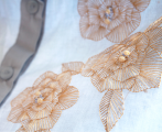 Sleeveless shirt with pleated basquine, gold embroidery & open back